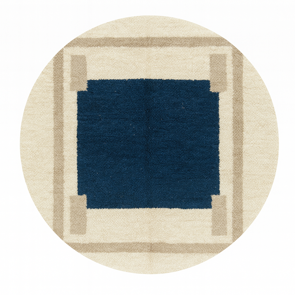 Round Moroccan wool rug with a navy blue center and beige geometric border.