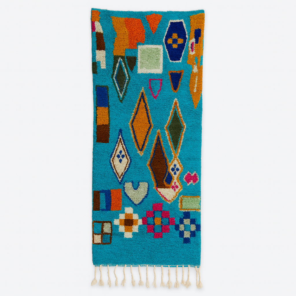 Handmade blue Moroccan wool runner rug with colorful Berber geometric motifs in orange, green, brown, navy, fuchsia, and cream