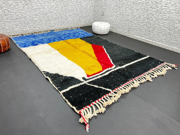 Handwoven Moroccan wool rug in blue, yellow, red, black, and white geometric pattern – modern Berber carpet handmade in Morocco