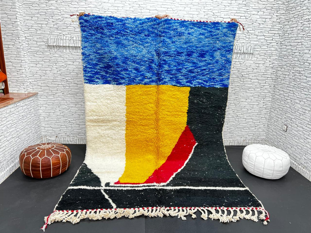 Handwoven Moroccan wool rug in blue, yellow, red, black, and white geometric pattern – modern Berber carpet handmade in Morocco