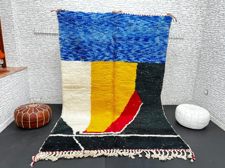 Handwoven Moroccan wool rug in blue, yellow, red, black, and white geometric pattern – modern Berber carpet handmade in Morocco