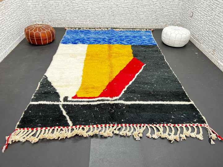 Handwoven Moroccan wool rug in blue, yellow, red, black, and white geometric pattern – modern Berber carpet handmade in Morocco