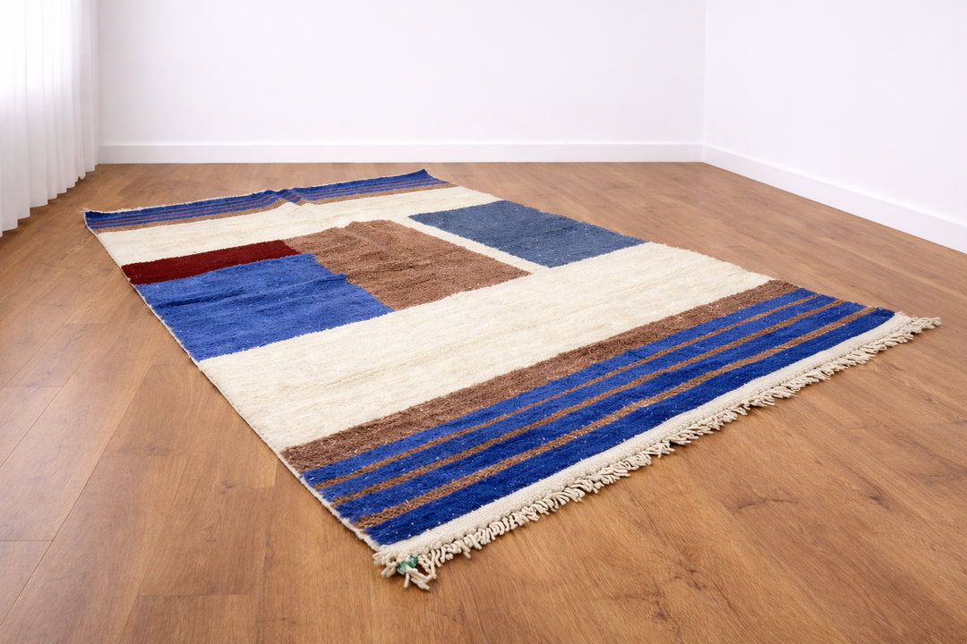 Handmade blue geometric Moroccan wool rug with cream background and Berber color-block design