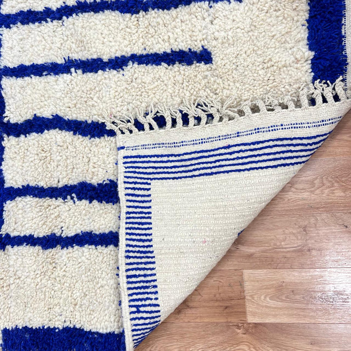 Handmade Moroccan wool rug with blue geometric Berber design. Soft plush texture, modern style, and artisan crafted.