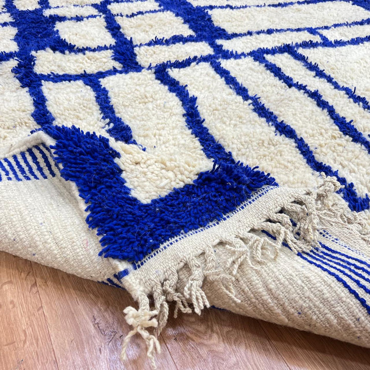Handmade Moroccan wool rug with blue geometric Berber design. Soft plush texture, modern style, and artisan crafted.