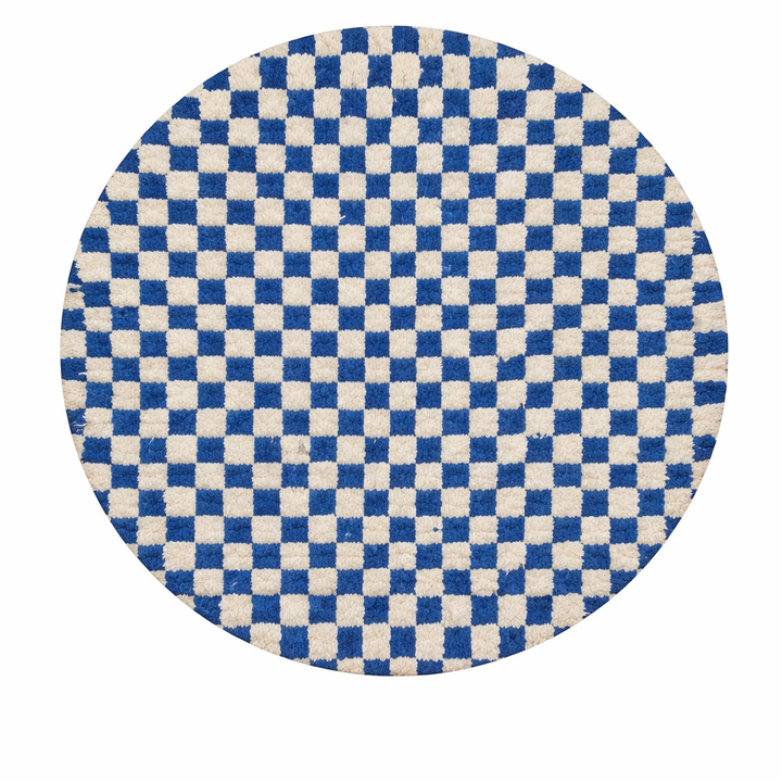 Handmade Moroccan wool rug with blue and white checkerboard pattern, round shape, and soft plush texture.
