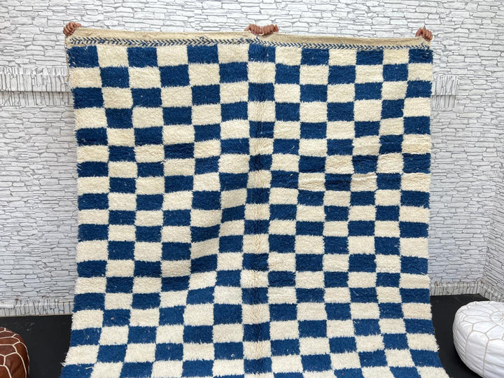 Handwoven blue and white Moroccan wool rug with checkerboard pattern
