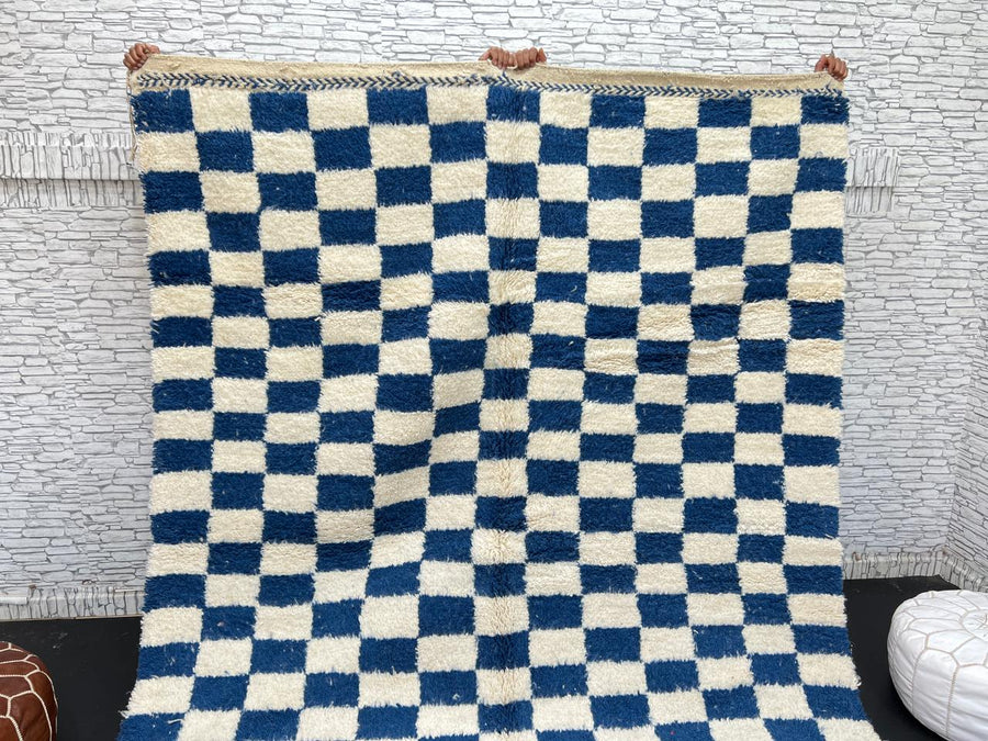 Handwoven blue and white Moroccan wool rug with checkerboard pattern