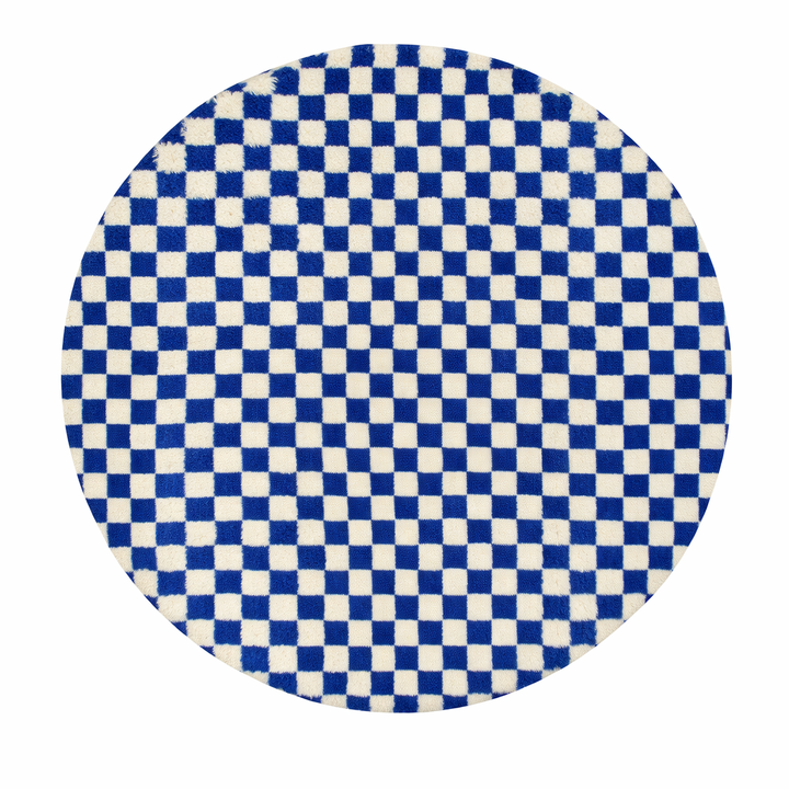 Round Moroccan wool rug with blue and white checkerboard pattern on a white background