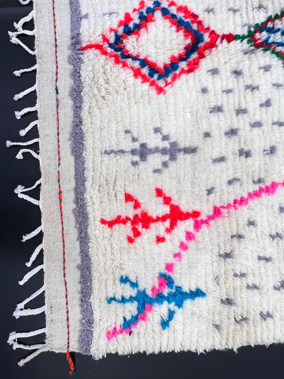 Handmade Moroccan Berber runner rug with white wool base, colorful diamond motif in pink, blue, turquoise and orange, boho tribal hallway runner carpet.