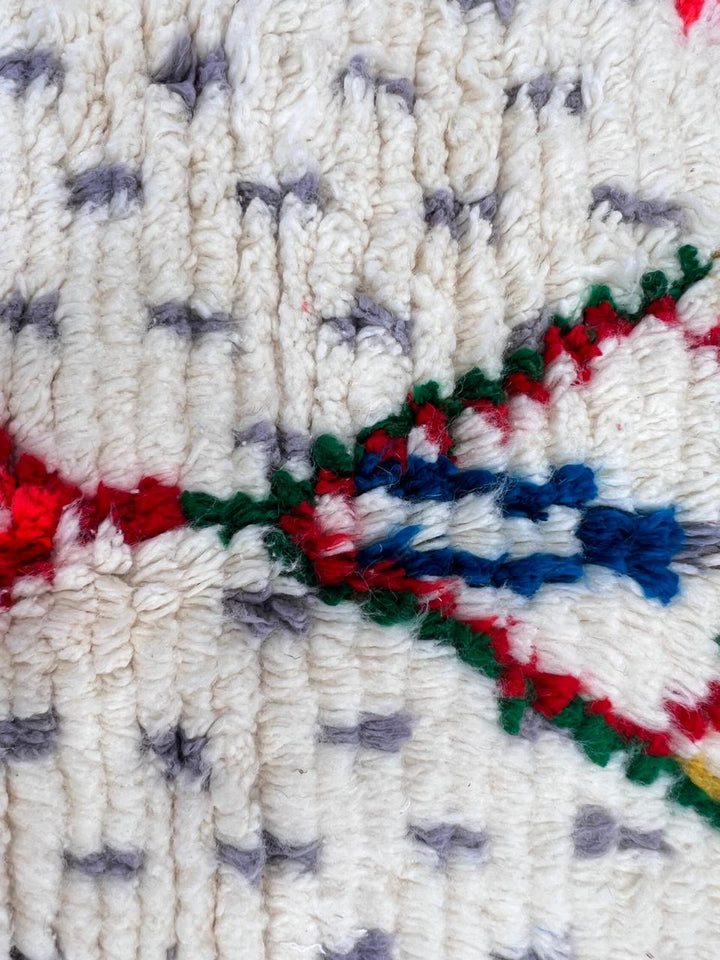 Handmade Moroccan Berber runner rug with white wool base, colorful diamond motif in pink, blue, turquoise and orange, boho tribal hallway runner carpet.