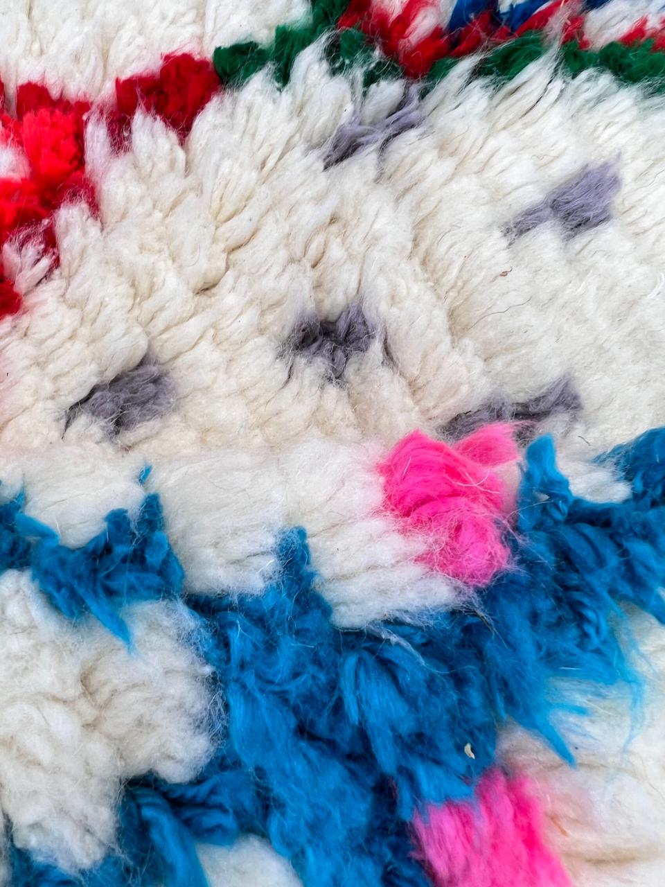 Handmade Moroccan Berber runner rug with white wool base, colorful diamond motif in pink, blue, turquoise and orange, boho tribal hallway runner carpet.