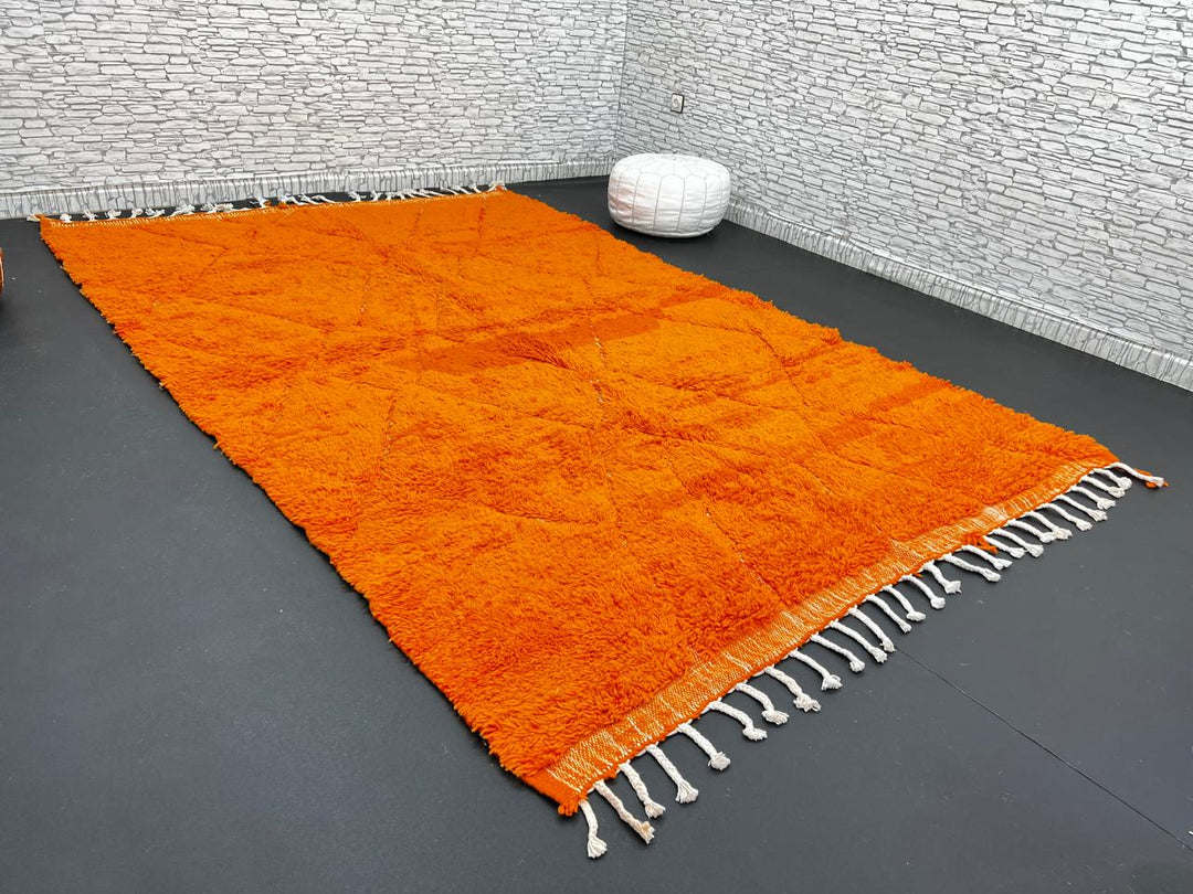 Handmade burnt orange Moroccan wool rug with diamond pattern and natural wool texture