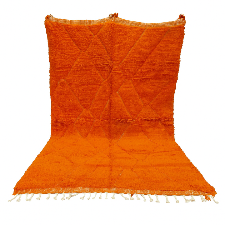 Handmade burnt orange Moroccan wool rug with diamond pattern and natural wool texture