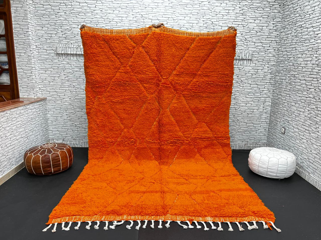 Handmade burnt orange Moroccan wool rug with diamond pattern and natural wool texture