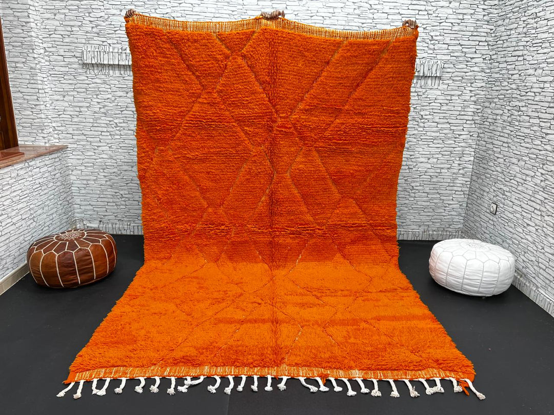 Handmade burnt orange Moroccan wool rug with diamond pattern and natural wool texture