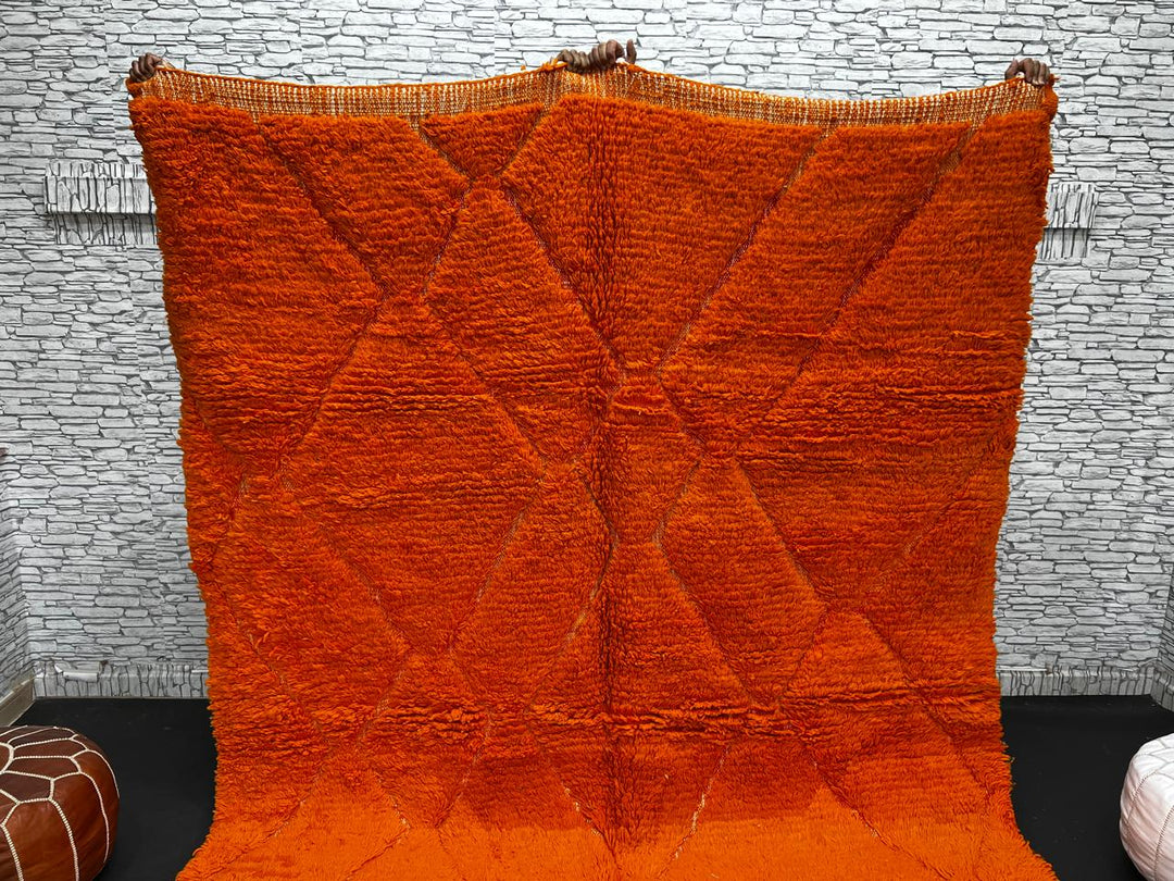Handmade burnt orange Moroccan wool rug with diamond pattern and natural wool texture