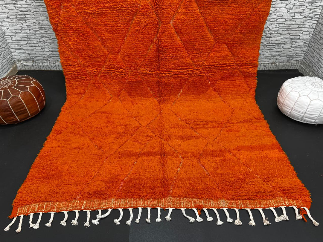 Handmade burnt orange Moroccan wool rug with diamond pattern and natural wool texture