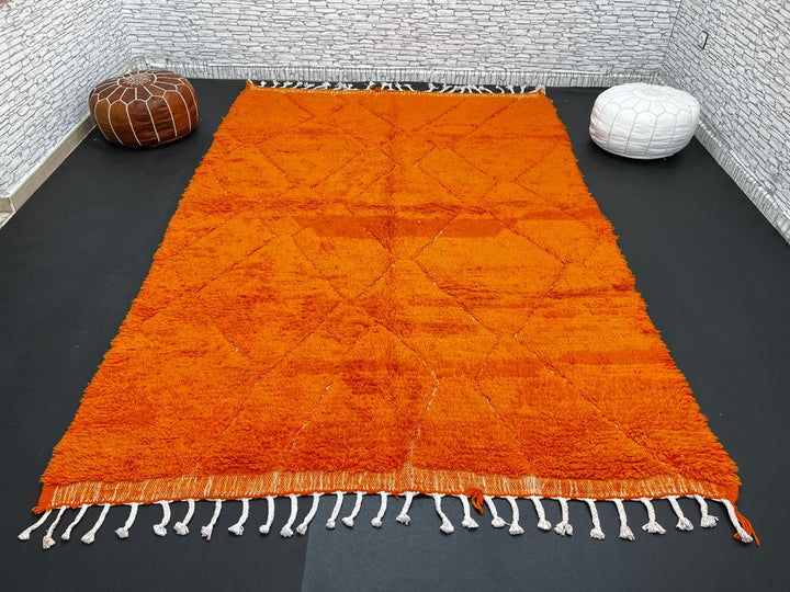 Handmade burnt orange Moroccan wool rug with diamond pattern and natural wool texture