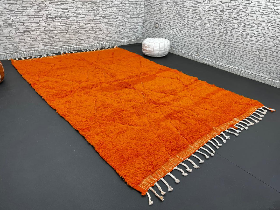 Handmade burnt orange Moroccan wool rug with diamond pattern and natural wool texture