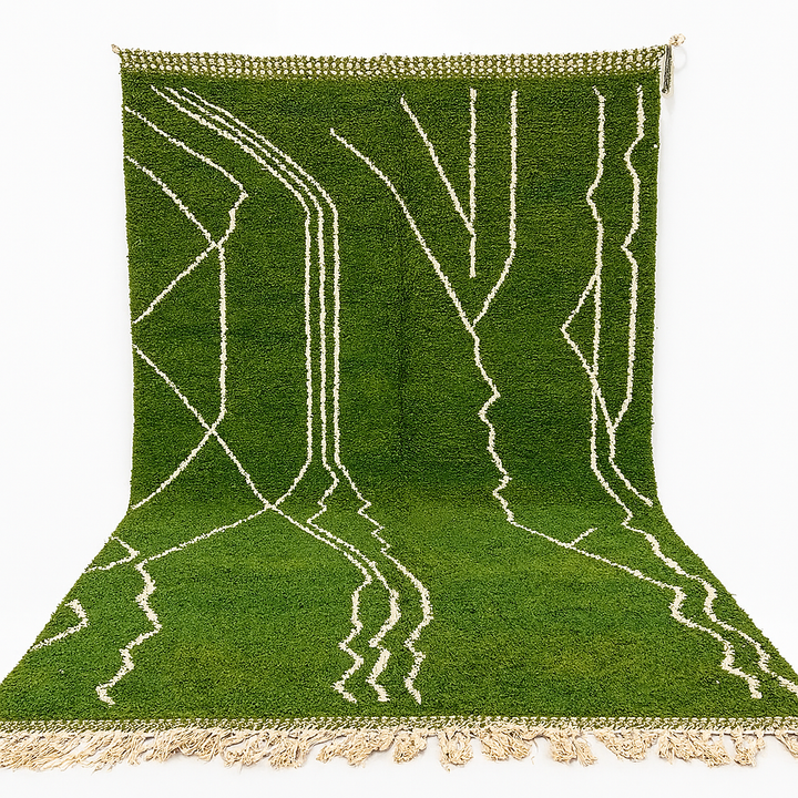 Green Moroccan Berber wool rug with white geometric patterns, handwoven by artisans, available as a traditional Moroccan carpet for sale.