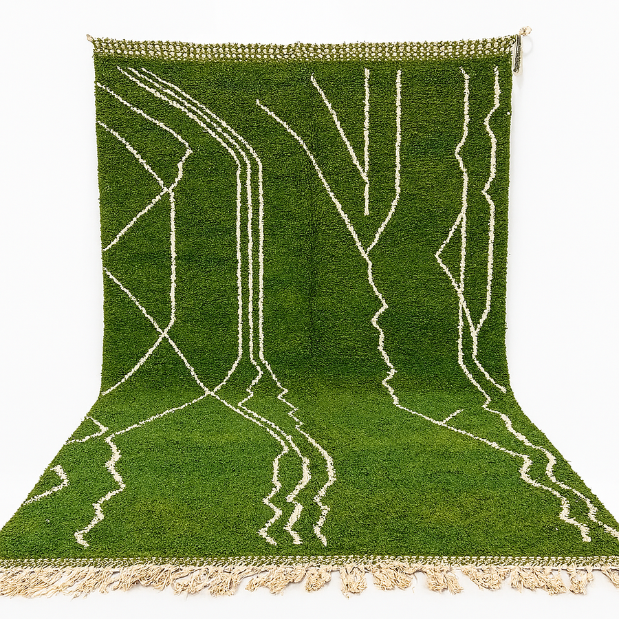 Green Moroccan Berber wool rug with white geometric patterns, handwoven by artisans, available as a traditional Moroccan carpet for sale.