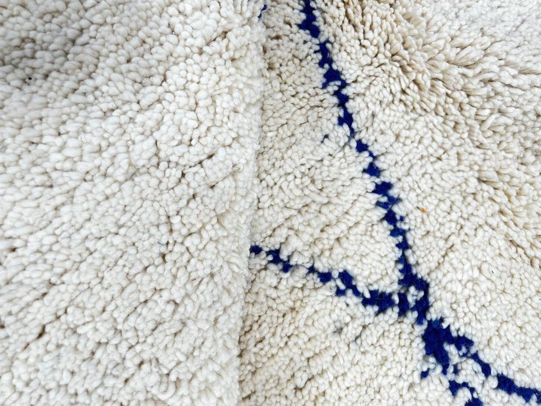 Ivory Moroccan wool rug with cobalt blue diamond lattice handmade by Berber artisans