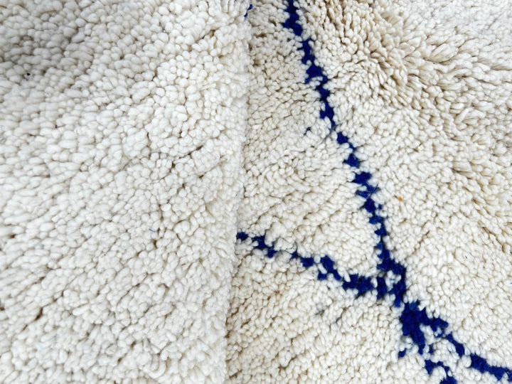 Ivory Moroccan wool rug with cobalt blue diamond lattice handmade by Berber artisans