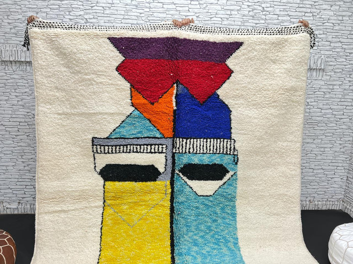 Handwoven Moroccan wool rug with bold geometric color blocks in blue, yellow, and red