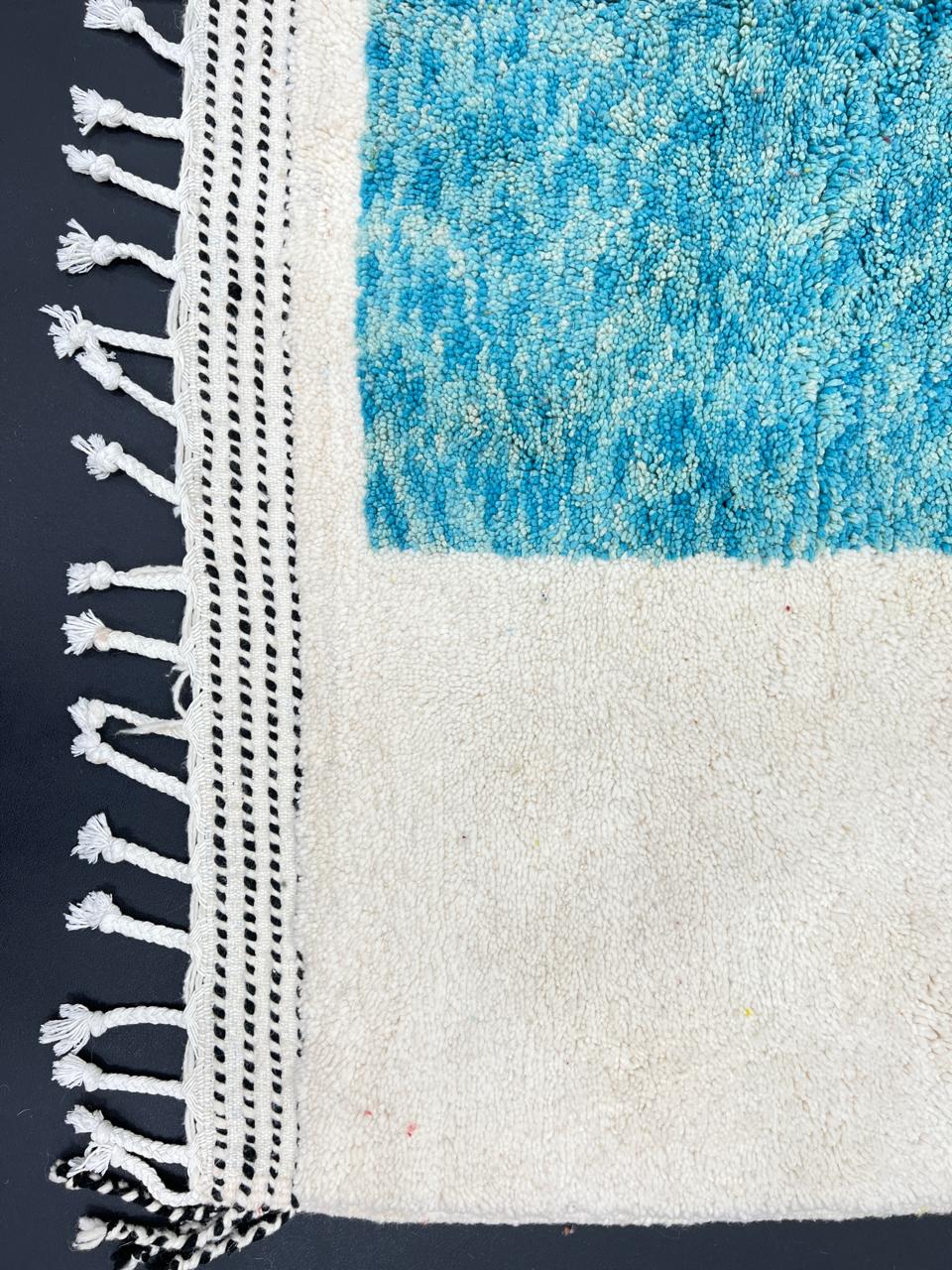 Handwoven Moroccan wool rug with bold geometric color blocks in blue, yellow, and red