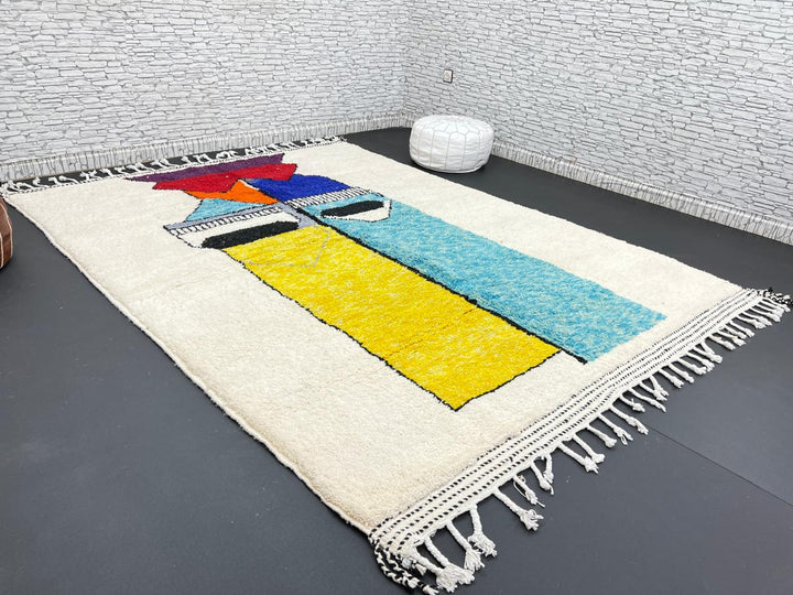 Handwoven Moroccan wool rug with bold geometric color blocks in blue, yellow, and red
