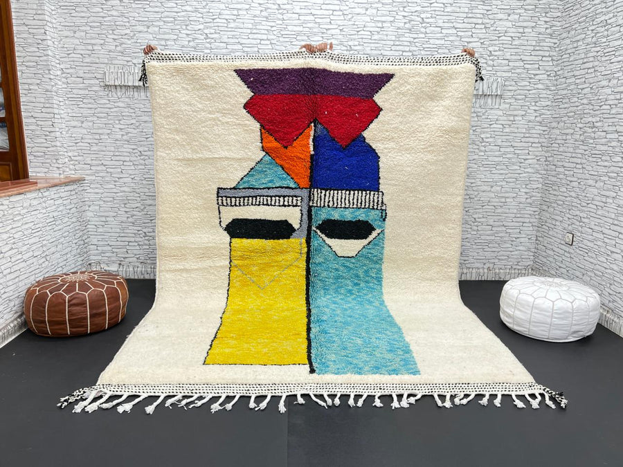 Handwoven Moroccan wool rug with bold geometric color blocks in blue, yellow, and red