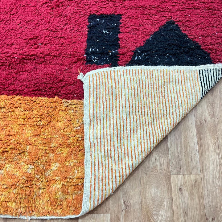 Modern handmade Moroccan wool rug with bold color-block design. Thick shag texture, artistic style, and ethically crafted in Morocco.