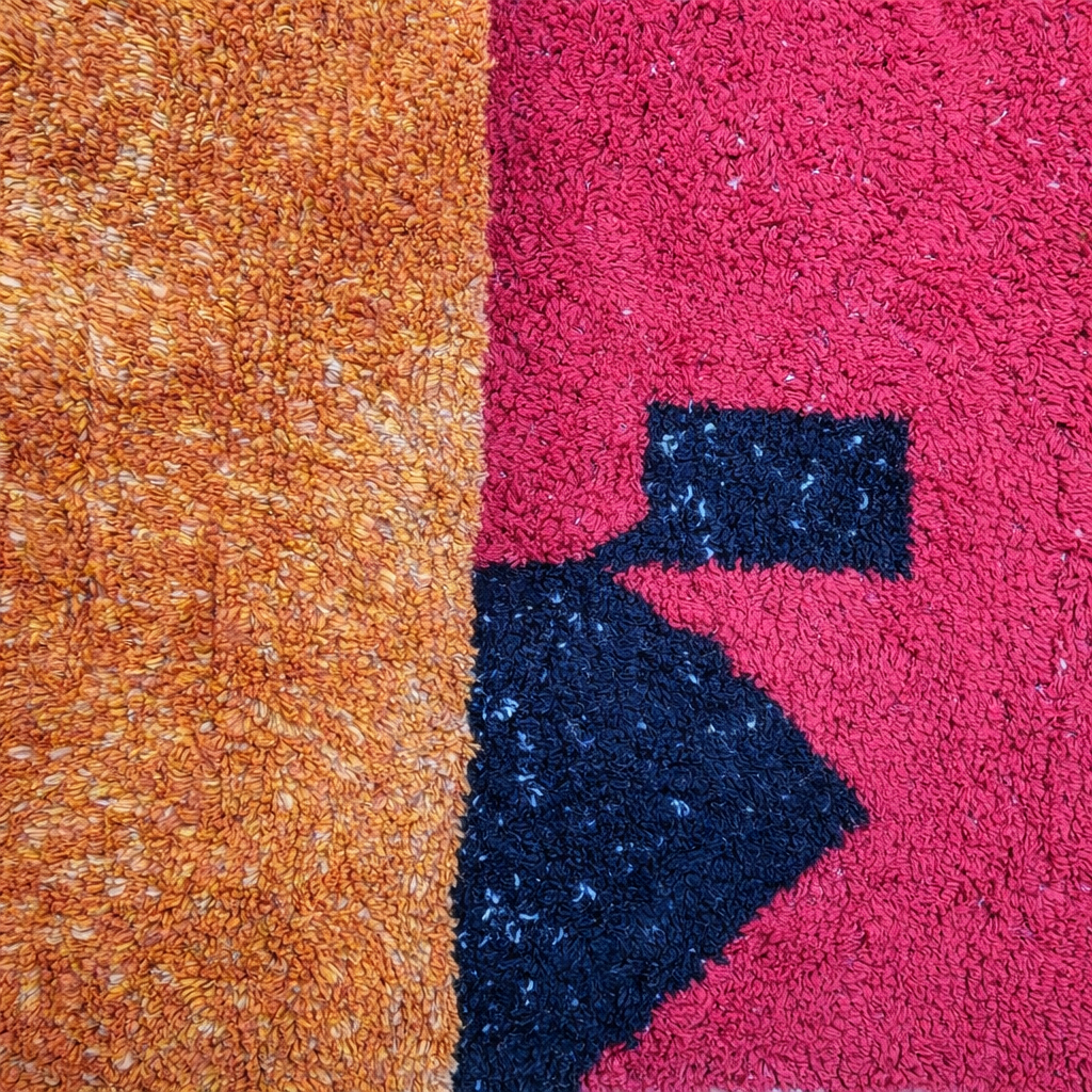 Modern handmade Moroccan wool rug with bold color-block design. Thick shag texture, artistic style, and ethically crafted in Morocco.