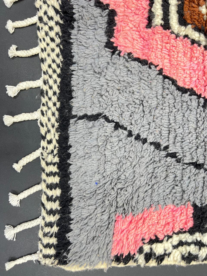 Colorful Moroccan wool runner rug with abstract artistic design in blue, pink, mustard, beige, and black tones