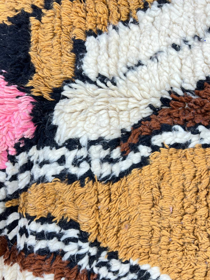 Colorful Moroccan wool runner rug with abstract artistic design in blue, pink, mustard, beige, and black tones