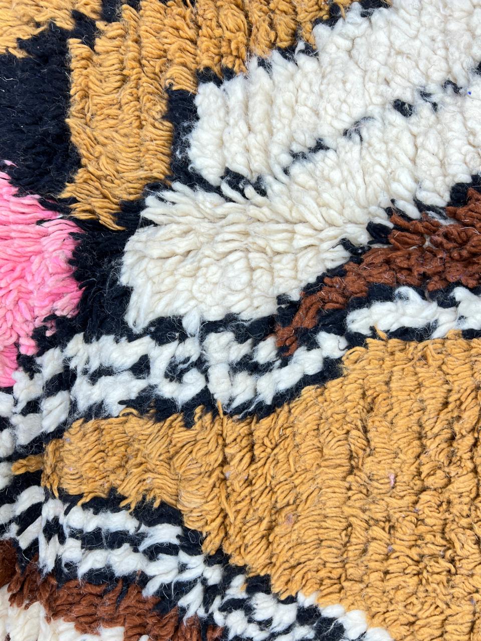 Colorful Moroccan wool runner rug with abstract artistic design in blue, pink, mustard, beige, and black tones