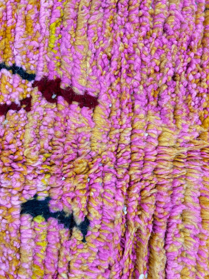 Handmade colorful Moroccan runner rug with abstract geometric design in orange, pink, green, and earthy tones, crafted from natural wool by Berber artisans.