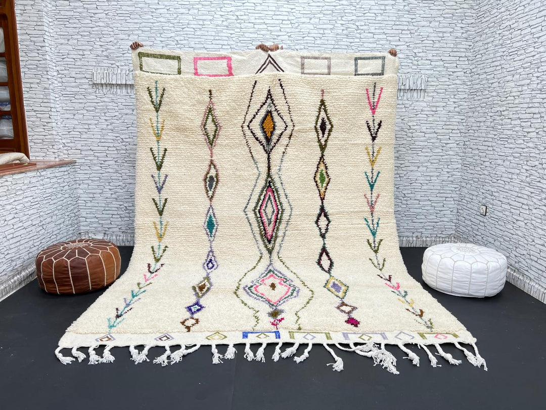 Handmade Moroccan Beni Ourain wool rug with colorful geometric diamond patterns on ivory background