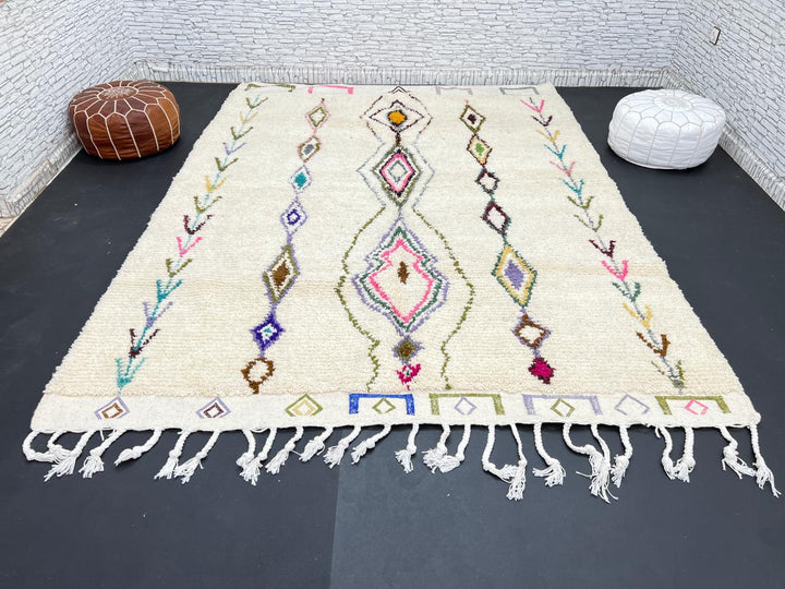 Handmade Moroccan Beni Ourain wool rug with colorful geometric diamond patterns on ivory background