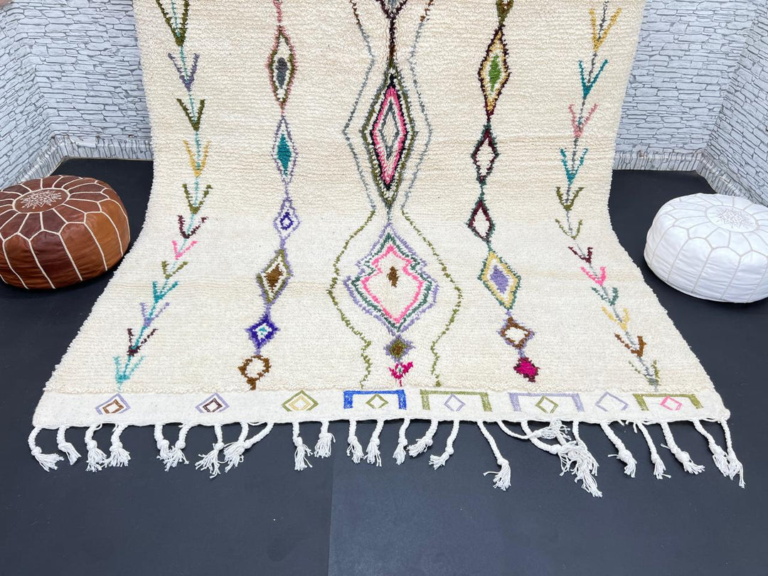 Handmade Moroccan Beni Ourain wool rug with colorful geometric diamond patterns on ivory background