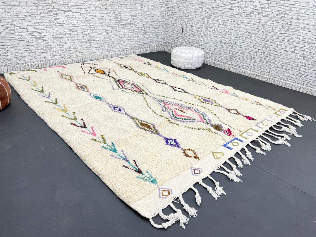 Handmade Moroccan Beni Ourain wool rug with colorful geometric diamond patterns on ivory background