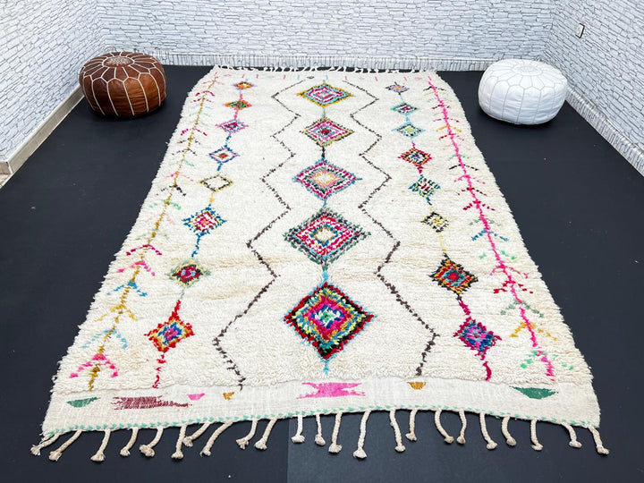Colorful Beni Ourain Moroccan wool rug with diamond tribal patterns in pink, turquoise, and green on ivory background