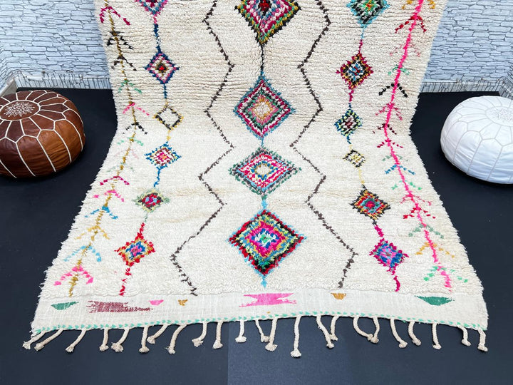 Colorful Beni Ourain Moroccan wool rug with diamond tribal patterns in pink, turquoise, and green on ivory background