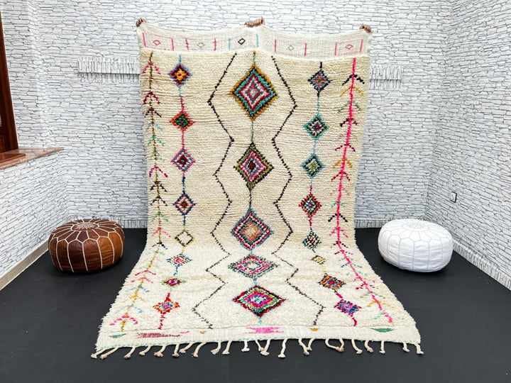Colorful Beni Ourain Moroccan wool rug with diamond tribal patterns in pink, turquoise, and green on ivory background