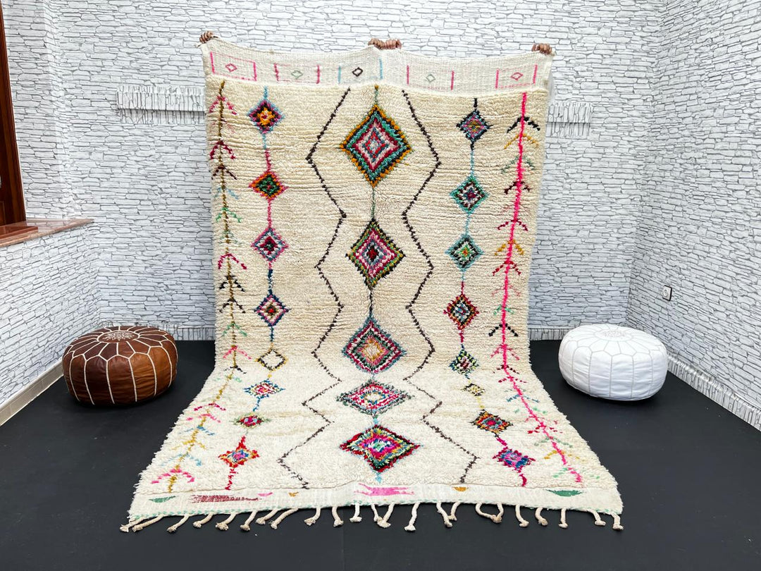 Colorful Beni Ourain Moroccan wool rug with diamond tribal patterns in pink, turquoise, and green on ivory background