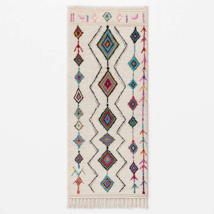 Handmade Moroccan wool runner rug with colorful Berber diamond motifs on a white background