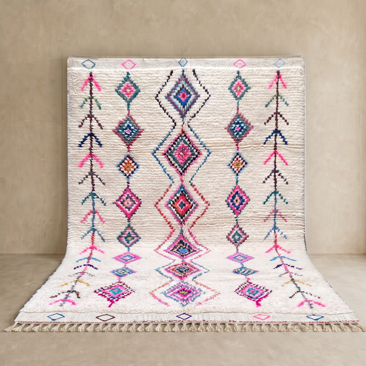 Colorful handmade Moroccan Berber rug with diamond tribal patterns on white wool
