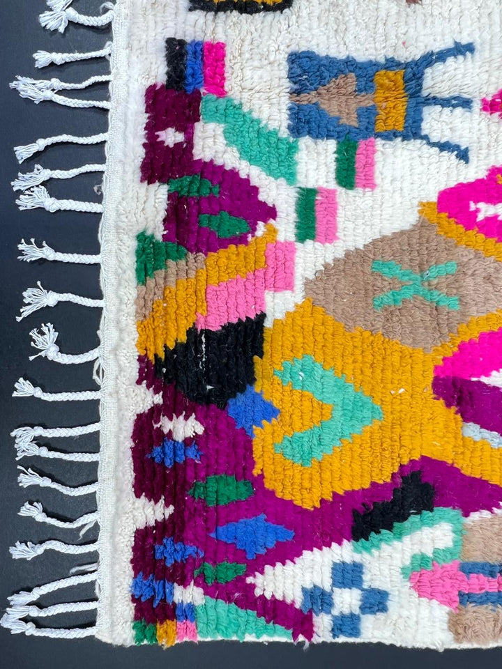 Colorful Berber Moroccan runner rug handmade from white wool with abstract symbols