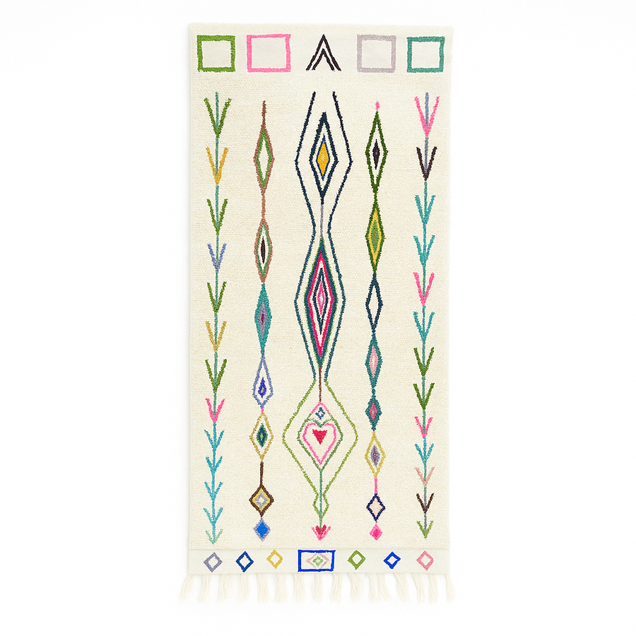 Handmade Moroccan runner rug with colorful geometric and tribal motifs on a white wool background, crafted by Berber artisans.